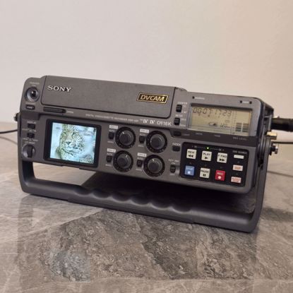 Picture of A working mini DVI camera tape player in excellent condition, Kuwait electrical system, clean, and can be connected to any external display screen via the three colored wires.